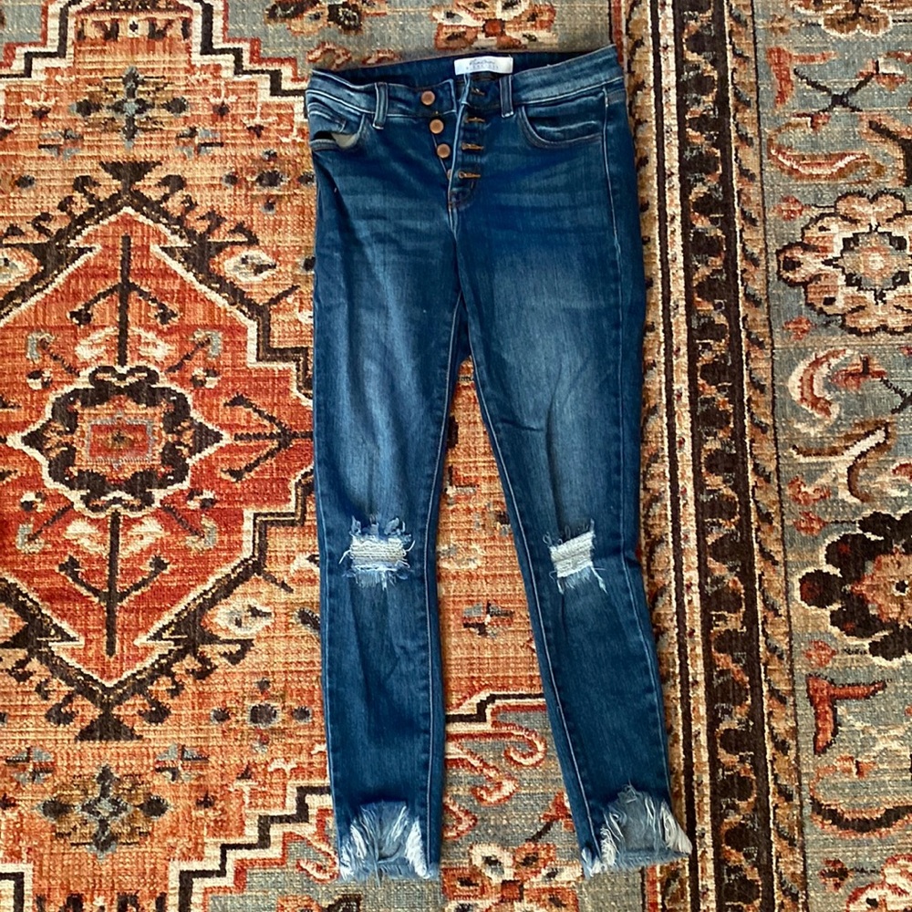 Medium wash blue KanCan skinny jeans with holes